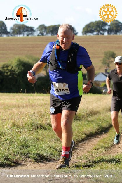 Jim Whitmarsh running through a field for Clarendon Marathon